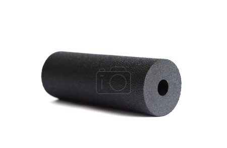 A black massage foam roller mini isolated on a white background. Close-up. Foam rolling is a self myofascial release technique. Concept of fitness equipment.