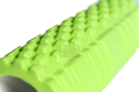 Photo for A green foam massage roller isolated on a white background. Foam rolling is a self myofascial release technique. Gym fitness equipment. - Royalty Free Image