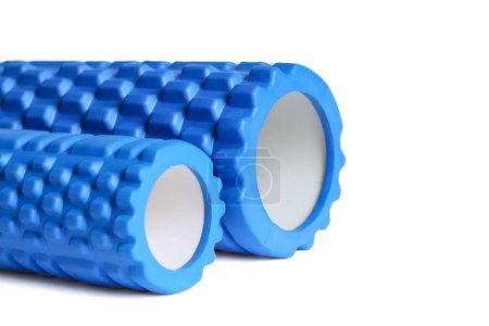 Two blue foam massage rollers isolated on a white background. Foam rolling is a self myofascial release technique. Gym fitness equipment.