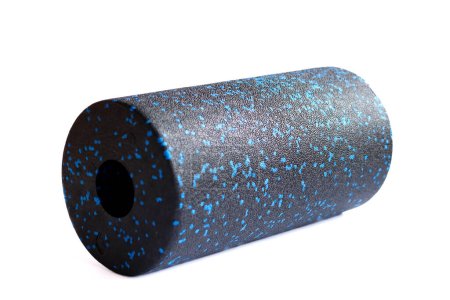 A black blue massage foam roller isolated on a white background. Close-up. Foam rolling is a self myofascial release technique. Concept of fitness equipment.