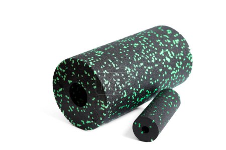 Photo for Massage set: A black green foam roller and mfr massage mini roller isolated on a white background. Close-up. Foam rolling is a self myofascial release technique. Concept of fitness equipment. - Royalty Free Image