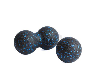 Massage set: A black blue ball and mfr double ball isolated on a white background. Close-up. Foam rolling is a self myofascial release technique. Concept of fitness equipment.