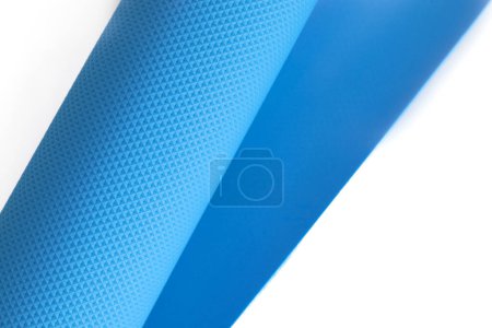Photo for A blue yoga mat isolated on a white background. Concept of fitness equipment. - Royalty Free Image