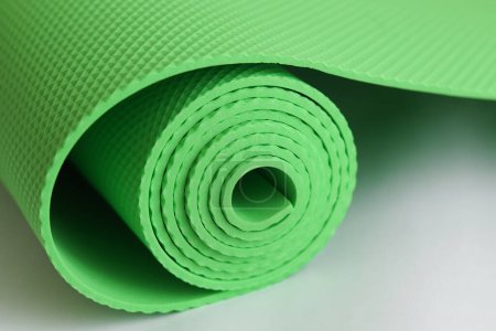 Photo for A green yoga mat isolated on a white background. oncept of fitness equipment. - Royalty Free Image