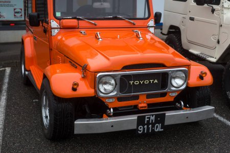 Photo for Mulhouse - France - 13 November 2022 - front view of orange color Toyota landcruiser customised parked in the street - Royalty Free Image