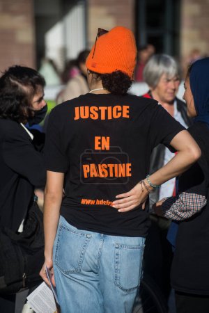 Photo for Strasbourg - France - 24 October 2022 - people protesting in the street with text in french on teeshirt : justice en palestine, traduction in english, justice in palestine - Royalty Free Image