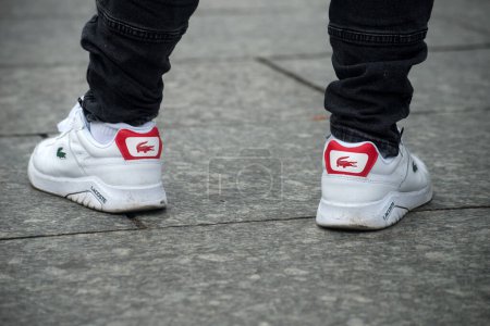 Foto de Strasbourg - France - 21 January 2023 - Closeup of man wearing a lacoste sneakers in the street - Imagen libre de derechos