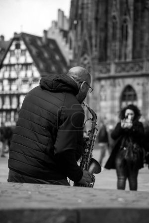 Photo for Strasbourg - France - 8 April 2023 - - Portrait of musician playing saxophone in the street - Royalty Free Image
