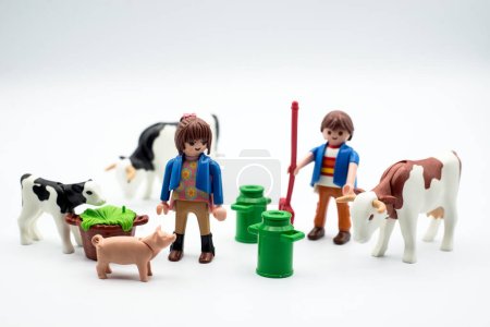 Photo for Mulhouse - France - 28 October 2023 - Closeup of farming playmobil figurines with animals on white background - Royalty Free Image