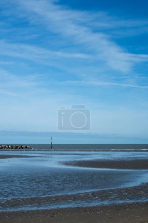 view of beach and sea on blue sky background