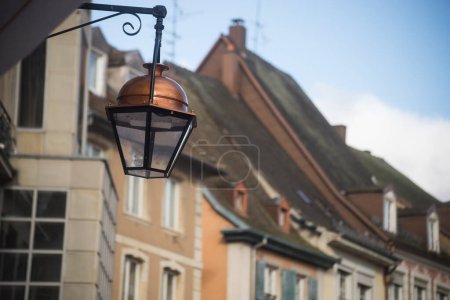 closeup of vintage street light on historic building facade background in Mulhouse - France