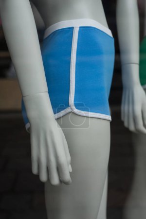 Closeup of blue shorty on mannequin in a fashion store showroom