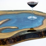 Coffee table, living room table. Resin handmade wood table. On a white background. Glass of whisky on the table. Glass of wine on the table.