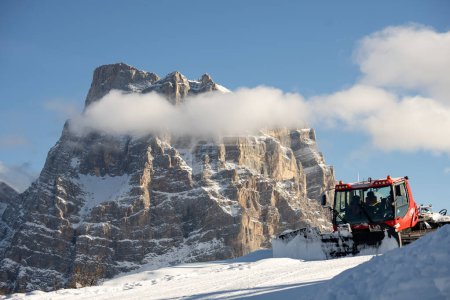 Téléchargez les photos : Piste toiletteuse en face des Alpes des Dolomites, Italie. dameuse à neige dans les Alpes dolomites en Italie. - en image libre de droit