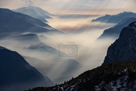 Photo for Snow covered Italian Dolomites at winter. Lake garda view in  Trentino-Alto Adige, Italy. Ski slopes and snow holidays in Andalo in the Italian Dolomites, ski resort in the Alps. - Royalty Free Image