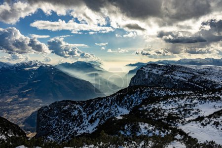 Snow covered Italian Dolomites at winter. Lake garda view in  Trentino-Alto Adige, Italy. Ski slopes and snow holidays in Andalo in the Italian Dolomites, ski resort in the Alps.