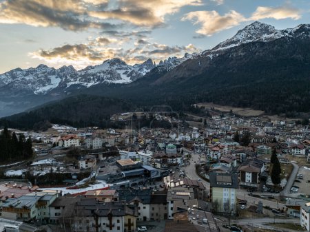Aerial drone view of Andalo town with mountains background in winter. Ski resort Paganella Andalo, Trentino-Alto Adige, Italy., Italian Dolomites,.Pagnella valley. Snow covered Italian Dolomites at winter. 