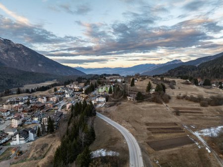 Photo for Aerial drone view of Andalo town with mountains background in winter. Ski resort Paganella Andalo, Trentino-Alto Adige, Italy., Italian Dolomites,.Pagnella valley. Snow covered Italian Dolomites at winter. - Royalty Free Image
