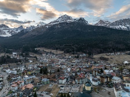 Aerial drone view of Andalo town with mountains background in winter. Ski resort Paganella Andalo, Trentino-Alto Adige, Italy., Italian Dolomites,.Pagnella valley. Snow covered Italian Dolomites at winter. 