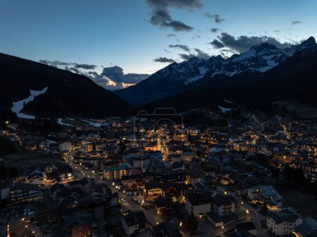 Photo for Aerial drone view of Andalo town at night  with mountains background in winter. Ski resort Paganella Andalo, Trentino-Alto Adige, Italy., Italian Dolomites,.Pagnella valley. Snow covered Italian Dolomites at winter. - Royalty Free Image