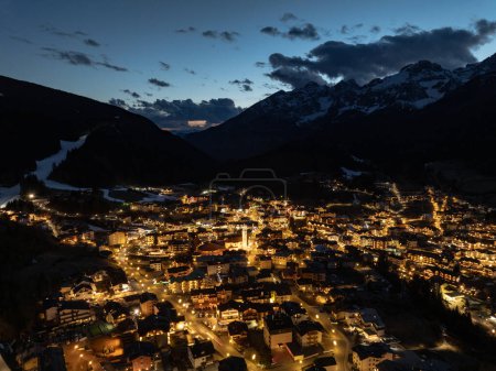 Photo for Aerial drone view of Andalo town at night  with mountains background in winter. Ski resort Paganella Andalo, Trentino-Alto Adige, Italy., Italian Dolomites,.Pagnella valley. Snow covered Italian Dolomites at winter. - Royalty Free Image