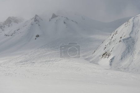 Freeride rally traces on powder snow. Kudebi, Bidara, Sadzele, Kobi aerial panorama in caucasus winter mountains. Aerial drone view of Gudauri ski resort in winter. Caucasus mountains in Georgia