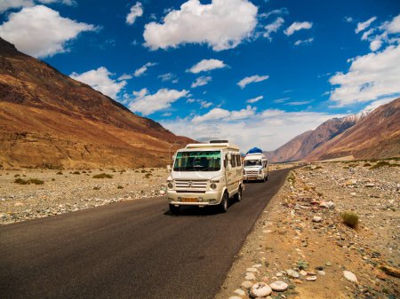 Photo for Leh, India - June 18, 2022: Tempo Traveller, highly used tourist vehicle on Mountain road of Ladakh, Northern India.Beautiful landscape of Ladakh, highest plateau in India. - Royalty Free Image