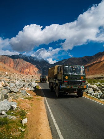 Photo for Leh, India - June 18, 2022: Indian Army truck on Mountain road of Ladakh, Northern India.Vertical or portrait orientation - Royalty Free Image