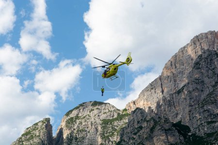 Photo for Fiames, Cortina d'Ampezzo, Dolomites, Italy - July, 6,  2022 : Helicopter Rescue Service. Medical first aid helicopter. Dolomites. Alps. Italy. - Royalty Free Image