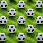 Group of soccer balls on football pitch. 3D illustration.