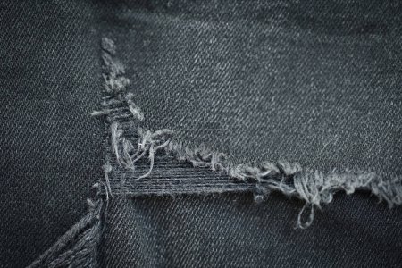 Foto de Desgarrado fondo de textura danim negro, textil de moda jeans para el diseño de ropa - Imagen libre de derechos