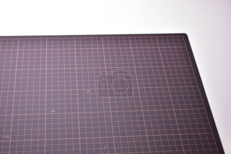 black cutting mat board on white background with line and scale measure guide pattern for object art design, tool equipment of diy craft work