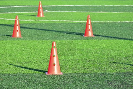 Photo for Artificial green grass soccer field with orange training cones - Royalty Free Image