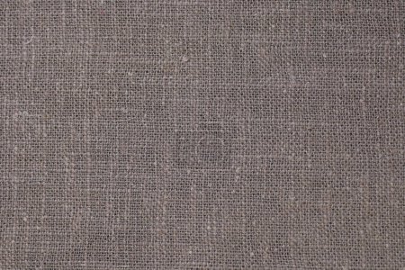 Foto de Drak marrón cáñamo viscosa tela natural tela color, saco textura áspera del fondo abstracto de la moda textil - Imagen libre de derechos