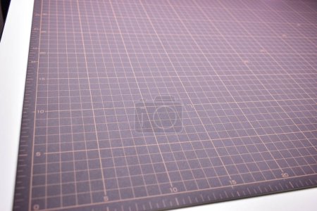 Photo for Black cutting mat board background with line and scale measure guide pattern for object art design, tool equipment of diy craft work - Royalty Free Image