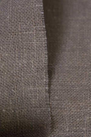 Foto de Drak marrón cáñamo viscosa tela natural tela color, saco textura áspera del fondo abstracto de la moda textil - Imagen libre de derechos