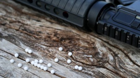 Photo for Close up plastic bullets of airsoft gun or bb gun on wooden floor, soft and selective focus on the bullets - Royalty Free Image