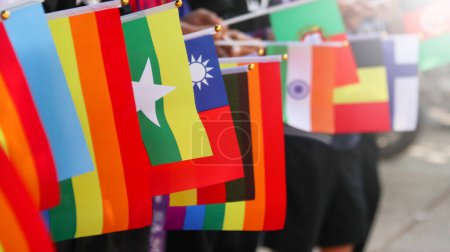 Foto de Bandera Rainbow LGBT ondeando en el fondo azul, enfoque suave y selectivo, espacio para copiar - Imagen libre de derechos