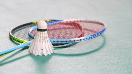 Téléchargez les photos : Navettes de badminton blanc et raquettes de badminton sur le terrain de badminton intérieur vert - en image libre de droit