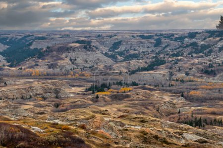 Photo for The Red Deer River snakes it's way through the badlands and under the full colour display of fa;;. Dry Island Buffalo Jump Provincial Park, Alberta, Canada - Royalty Free Image