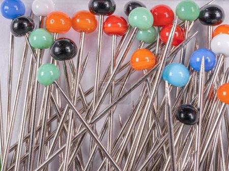 Photo for Background from sewing pins with multi-colored round heads on a light background - Royalty Free Image