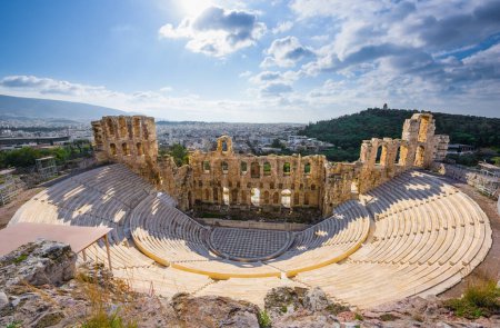 Photo for Odeon of Herodes Atticus, an ancient Roman and Classical Greek theater on the Acropolis slopes, near the Parthenon, with rows of circular seating and stone structure backlit by the sun, Athens, Greece - Royalty Free Image