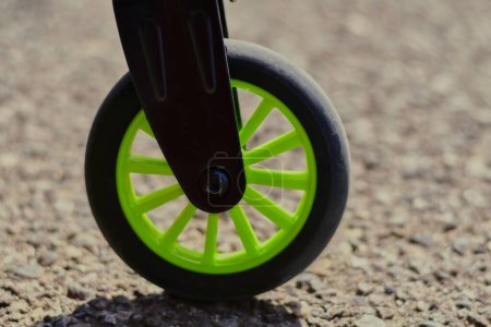 Téléchargez les photos : Rouler sur l'asphalte : un gros plan sur la roue du scooter - en image libre de droit