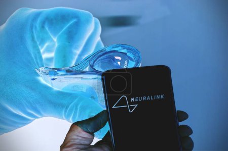 Photo for August 15th 2023 , Florence, Italy . Person holding smartphone with logo of US neurotechnology company Neuralink Corporation on screen in front of website. Focus on phone display. - Royalty Free Image