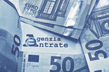 Many euro banknotes with the Modello 730 as background , translating in Italian as declaration of incomes , concept of tax payment .