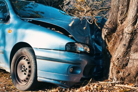 Details of a damaged car crashed against a tree