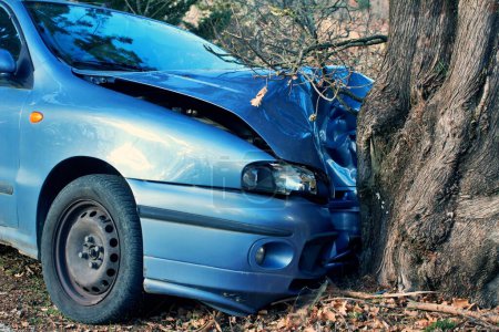 Details of a damaged car crashed against a tree
