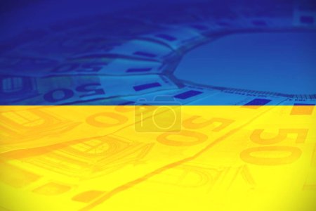 Viel Papier 150-Euro-Banknoten auf ukrainischer Flagge. Ansicht von oben. Konzept der Geldhilfe