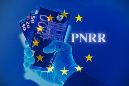 Hand holding euro banknotes with sign "Pnnr" concept of financial help