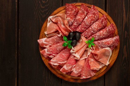 Photo for Assortment , sliced meat appetizer, prosciutto, salami and ham, with olives, breakfast, top view, close-up, no people, - Royalty Free Image